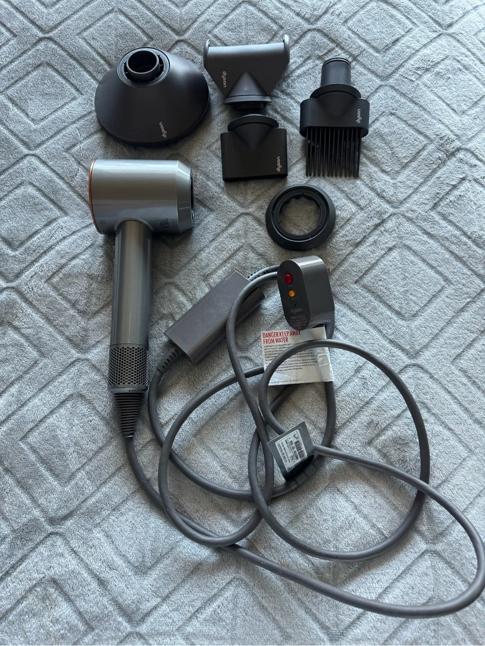 Dyson Hair Dryer with Multiple Black and Gray Styling Attachments